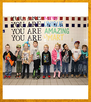 Students lined up under words You are kind. You are unique. You are amazing. You are smart.