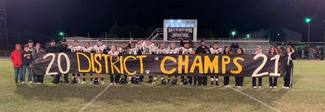 Football team holding up district champs banner