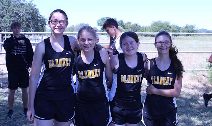 four happy girls on the cross country team