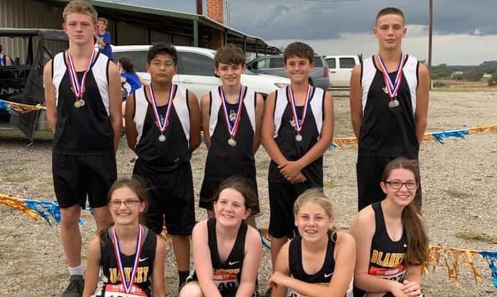 Cross country athletes wearing medals